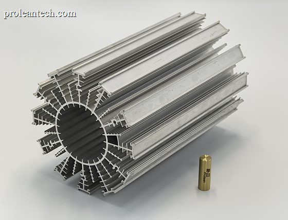 A machined aluminium heat sink with pin fins, next to a small brass machined fitting