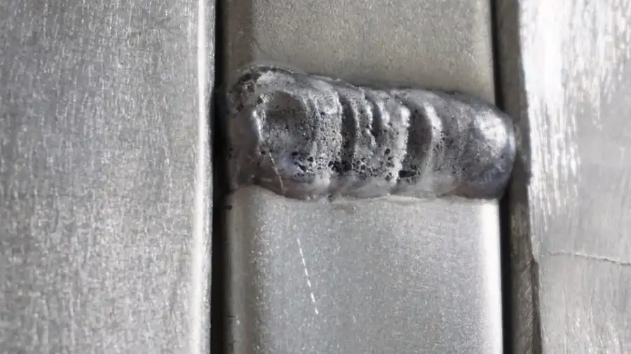 An image showing hot cracking on aluminum weld parts.