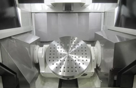 CNC machine tooling plate with precision-reamed aerospace pinholes arranged in a circular pattern