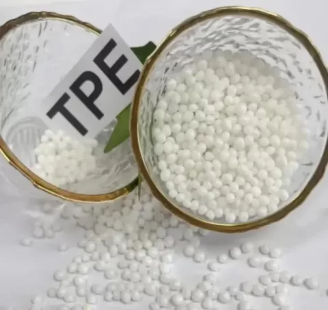 White recycled TPE pellets in gold-rimmed glass bowls