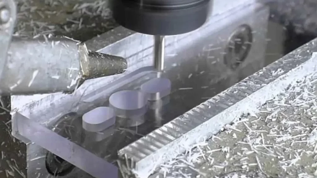 A machine milling a clear plastic part