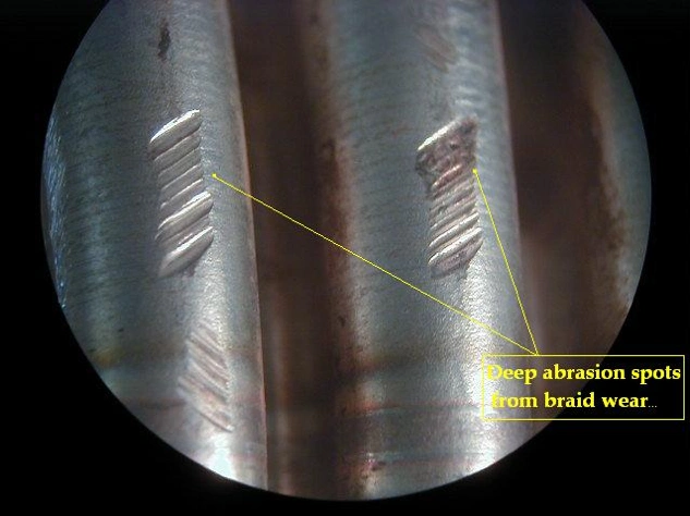 Large marks of abrasive wear marked with arrows