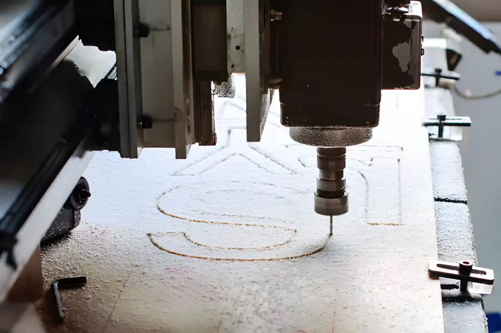 Text being engraved on a wooden sheet using a laser engraving machine.