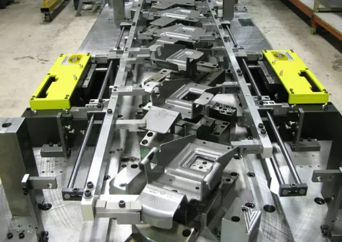 Multi-station transfer die with yellow automation components and formed metal cavities
