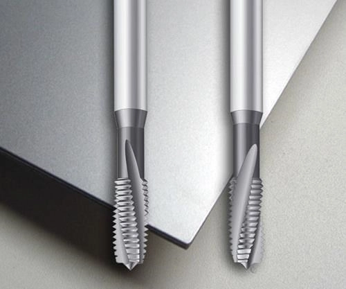 A display of titanium tapping tools on a titanium sheet.