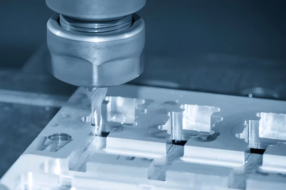 Aluminium part being milled on a CNC machine with a cutting tool in action.