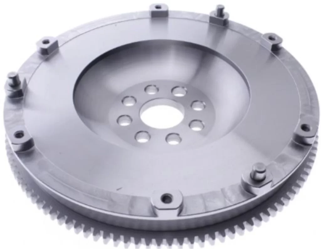 A closeup image of a single mass flywheel with a bore and mounting holes