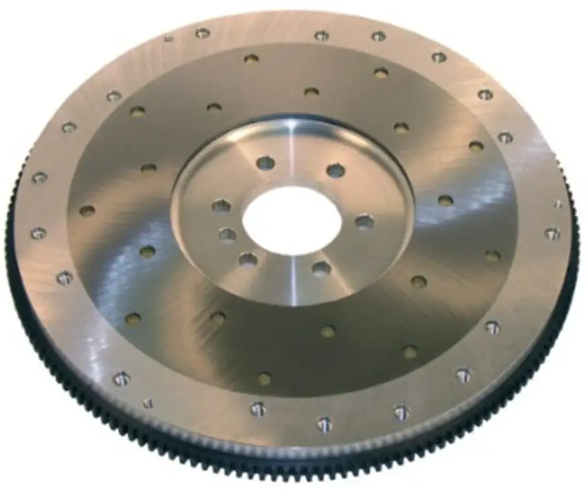 A closeup image of an aluminum flywheel with multiple holes and a toothed outer ring
