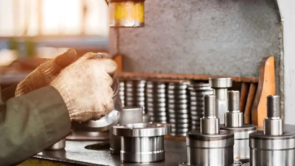 Worker handling components on a press fit machine.