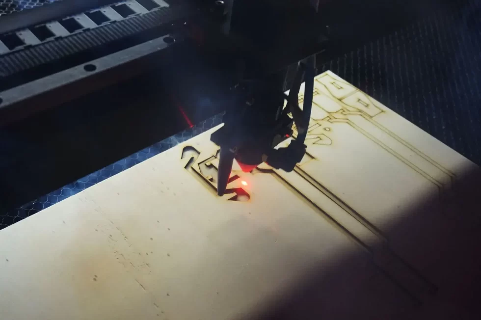 Laser cutter precisely cutting a thin Mylar plastic sheet.