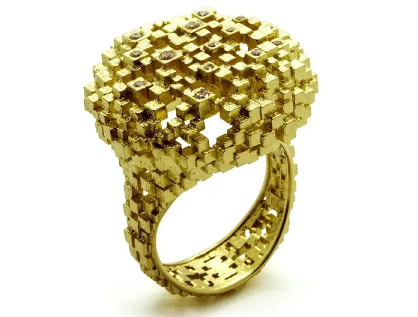 Gold 3D printed ring with intricate cube lattice pattern and embedded gemstones