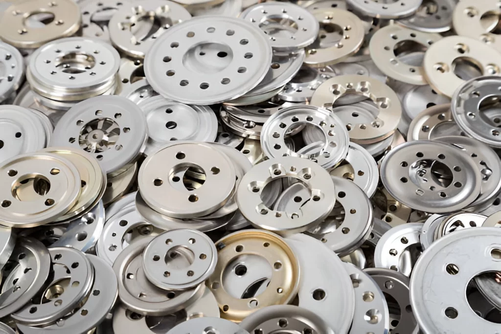 Pile of metal stamped parts stacked together.