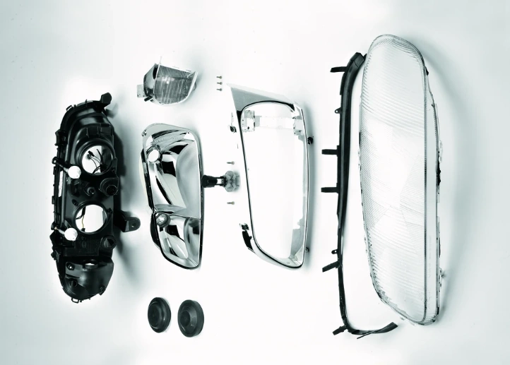 An image of different car headlight components placed next to each other