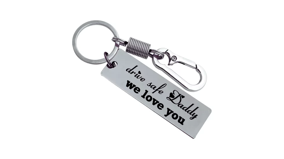 The image shows a black stainless steel keychain customized with laser engraving, designed as a gift from a daughter to her dad.