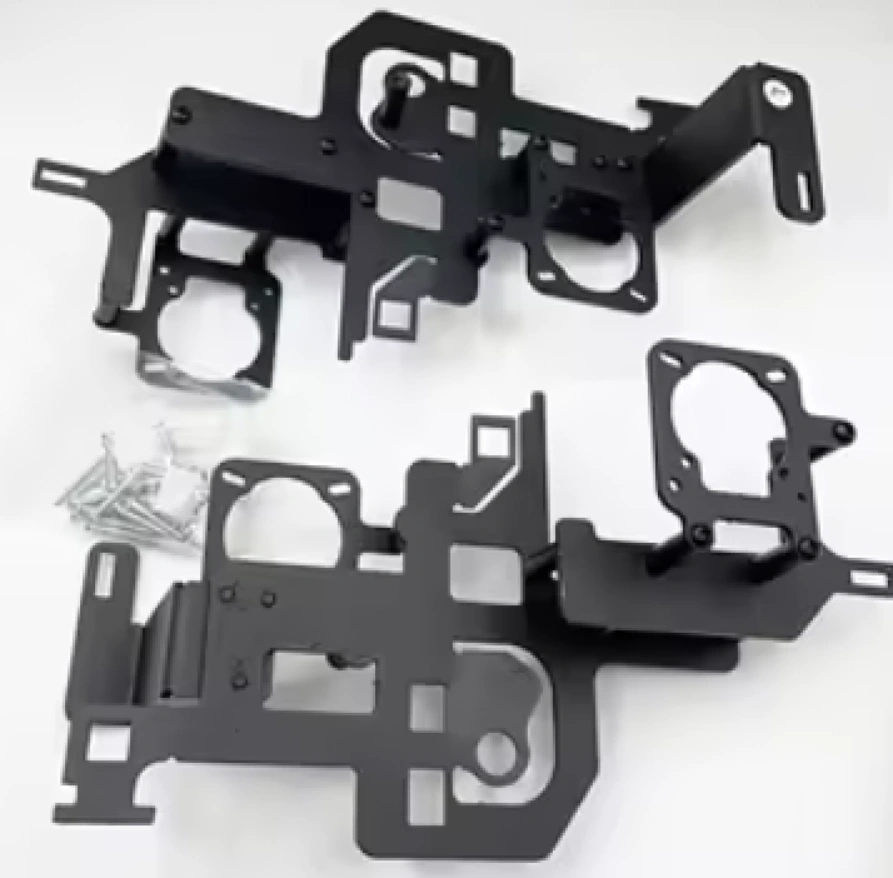 A closeup of two black car headlight brackets