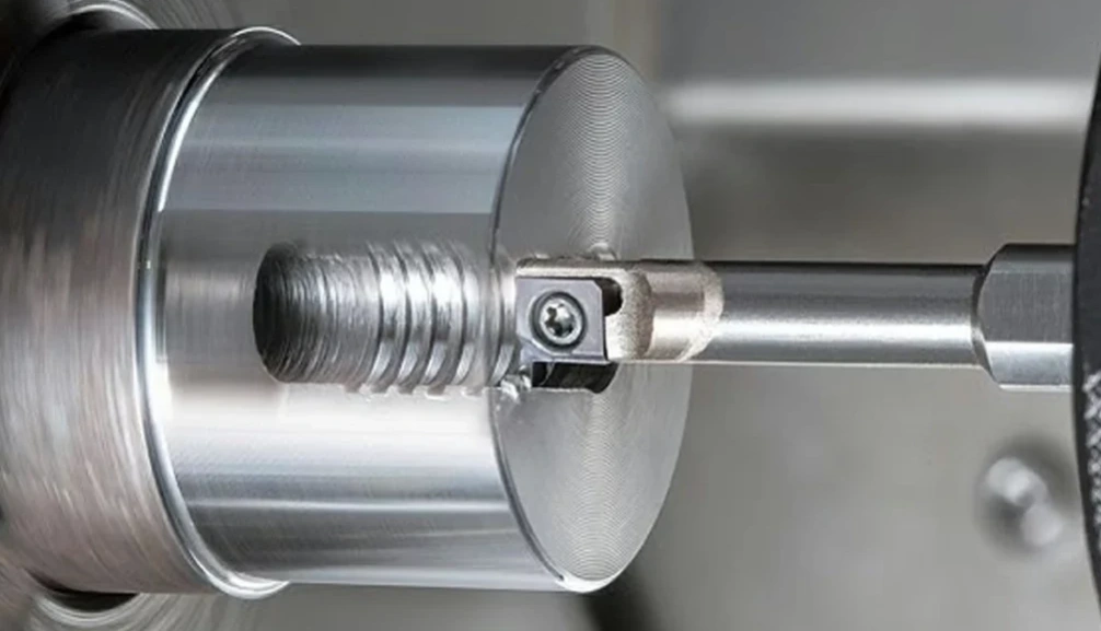 CNC lathe grooving operation on cylindrical metal workpiece