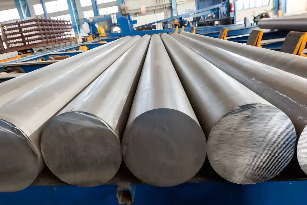 Stacked aluminum 6061 rods stored in a factory warehouse.