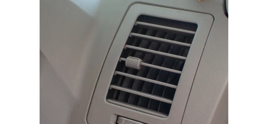Brown ABS plastic air vent of a car with slots