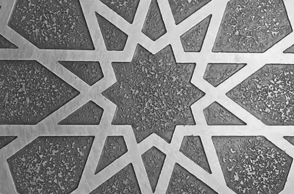 Intricate geometric patterns etched into a metal sheet