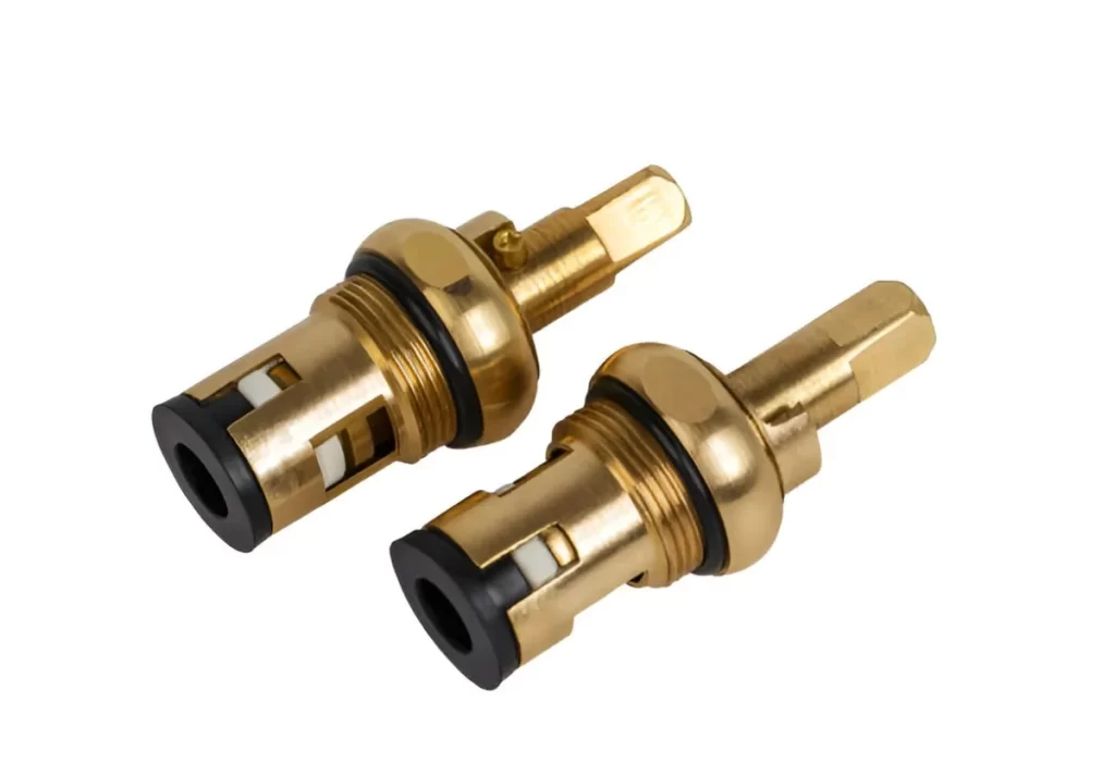 The image shows a pair of brass faucet cartridge parts for a water valve, displayed on a clean white background.