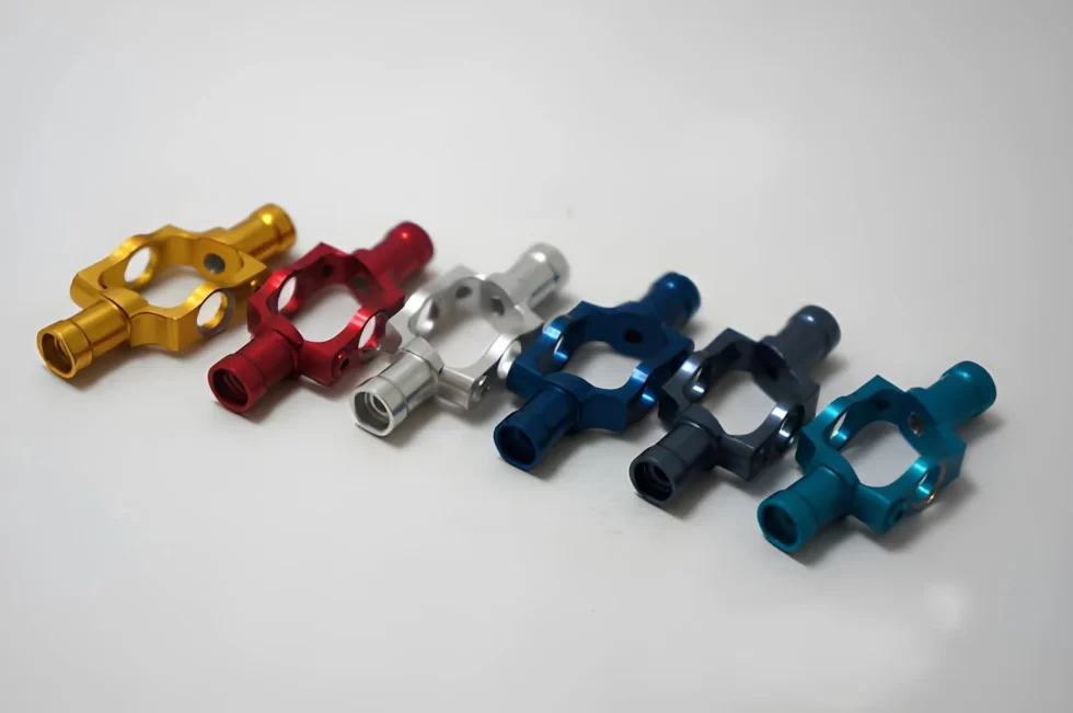 The image shows identical anodized aluminum parts displayed in multiple colors. 