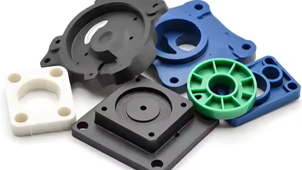 Collection of machined HDPE components, including mounting plates, flanges, and circular parts in white, black, blue, and green. 