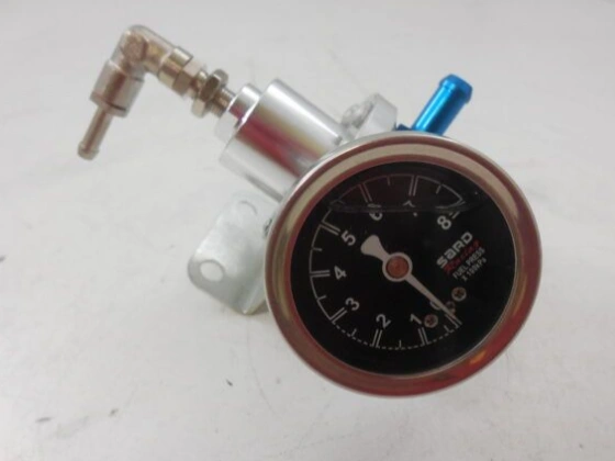 A closeup image of a gauge with metallic extensions showing a pressure regulator
