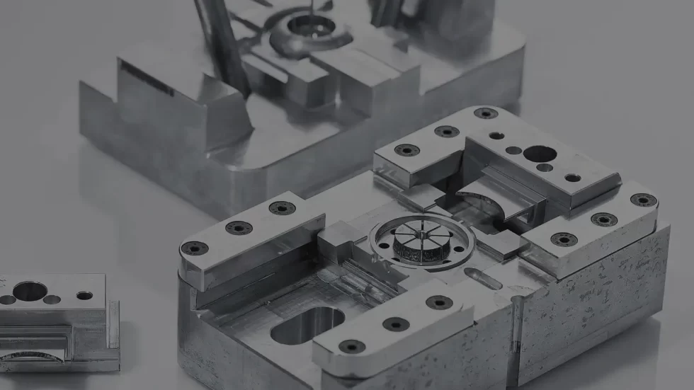 Alt text: Various black plastic automotive parts made using rapid tooling.