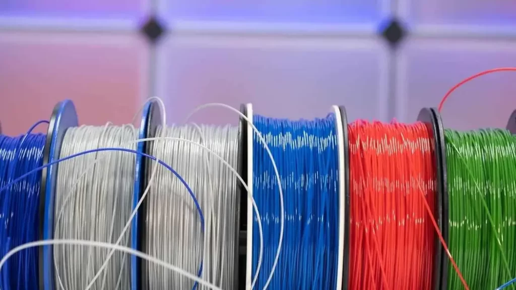 An image of PETG filament spool in diverse colors. It depicts durable and flexible material for 3D printing