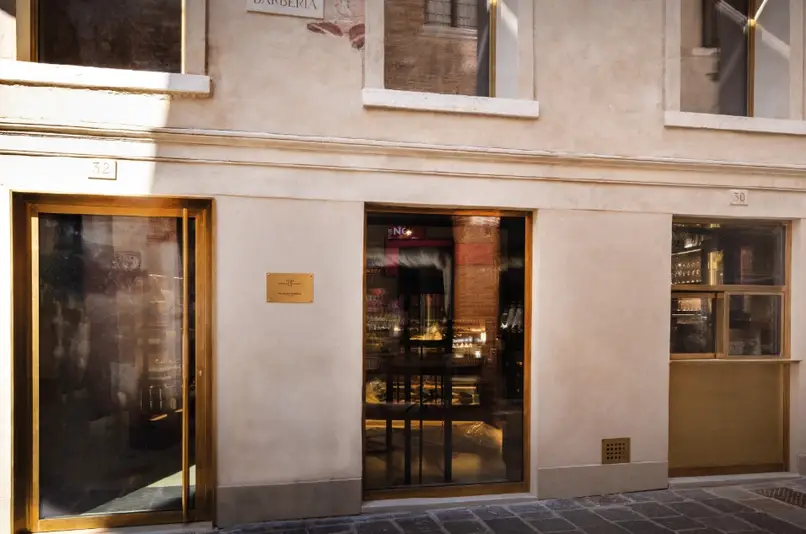 Architectural bronze-framed storefront entrance with sheet metal fabricated door and window frames