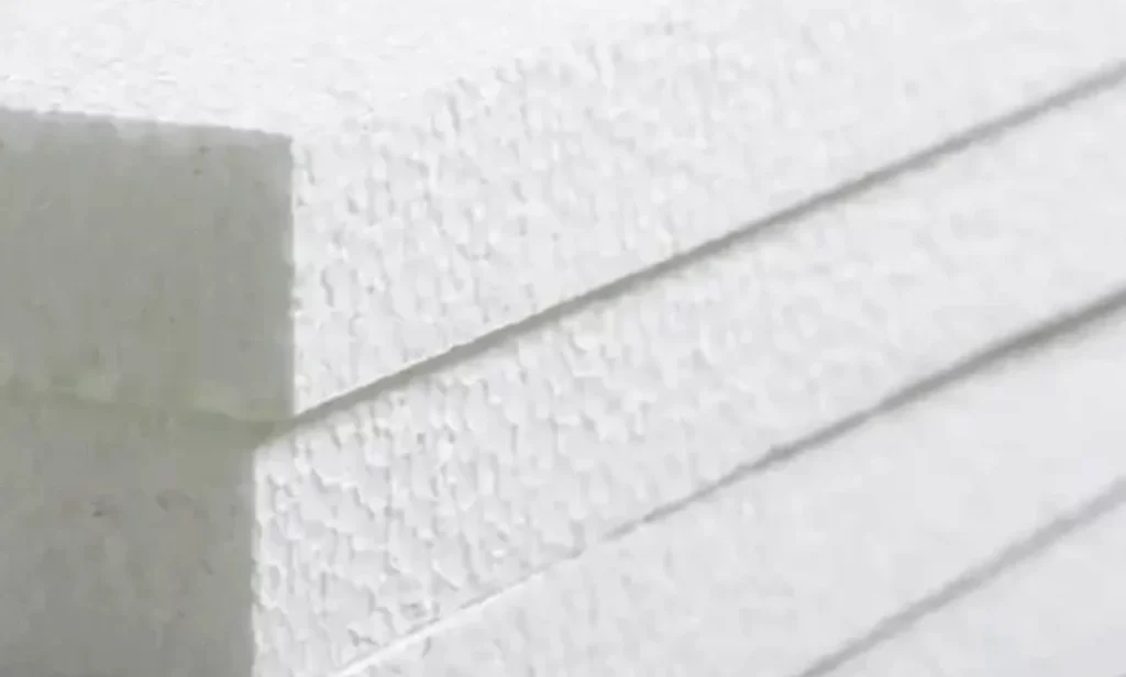 Alt text: Close-up view of stacked white expanded polystyrene (EPS) foam sheets showing their textured surface